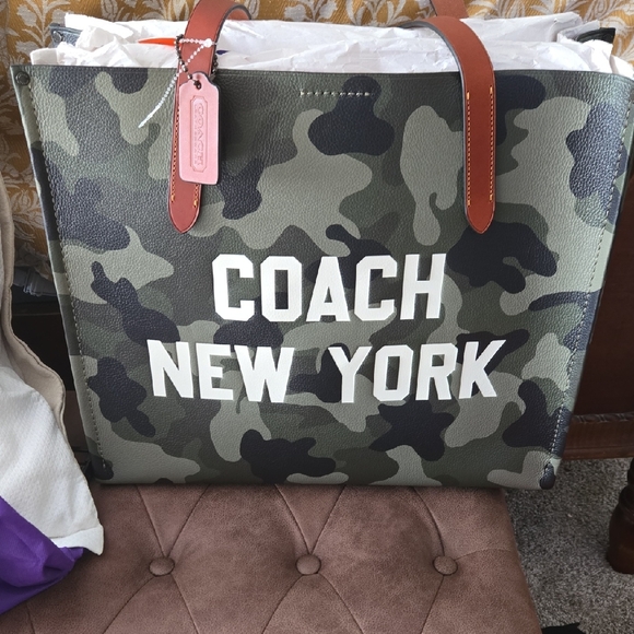 Coach Handbags - Coach Camouflage Tote with White Logo and Brown Handles